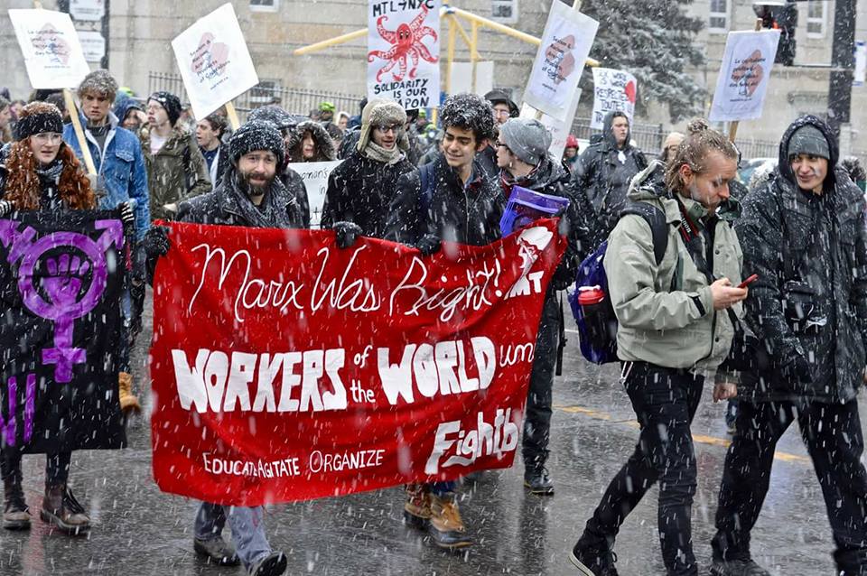 Women poses with Fightback journal during International Working Women's Day march